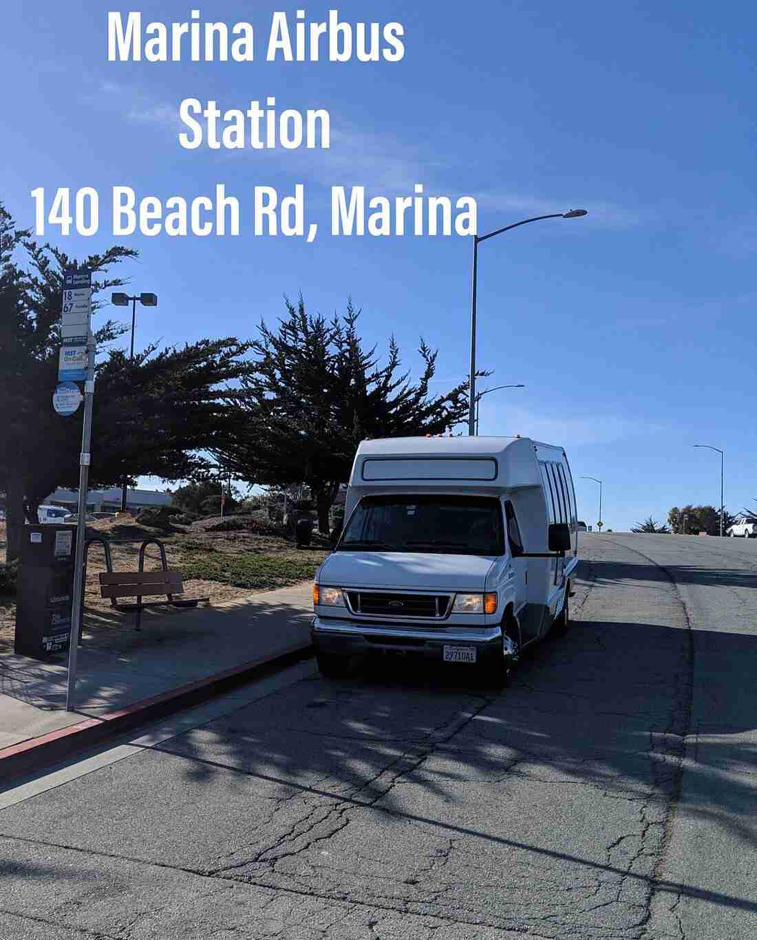 Monterey Airbus shuttle van parked at the designated Marina pick-up location, ready for boarding passengers.