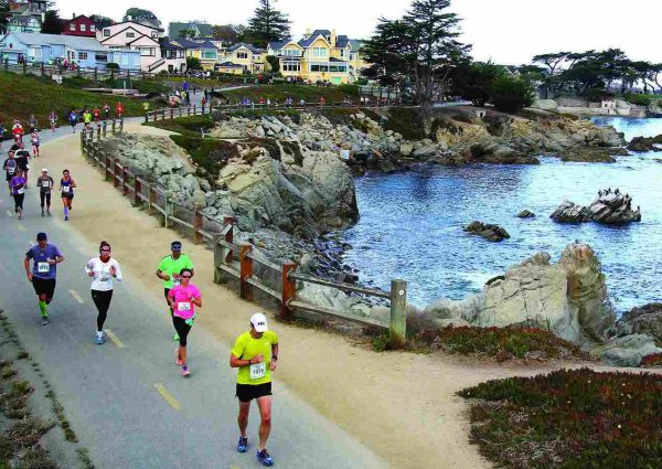 Runners enjoying the scenic coastal path in the Monterey Bay Half Marathon, with the ocean in the background.Runners enjoying the scenic coastal path in the Monterey Bay Half Marathon, with the ocean in the background.